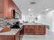 Open-concept kitchen with stainless steel appliances, mosaic backsplash and granite countertop bar seating area at 3120 Ginger Cir, Orlando, FL 32826