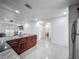 Bright open concept kitchen with stainless appliances, granite countertops, with an adjacent bathroom and door access at 3120 Ginger Cir, Orlando, FL 32826