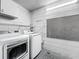 Functional laundry room equipped with modern washer and dryer, and convenient storage solutions at 3120 Ginger Cir, Orlando, FL 32826