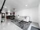 Open-concept living area with tile flooring, kitchen and modern furniture, offering a bright and airy space at 3120 Ginger Cir, Orlando, FL 32826