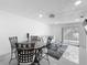 Living room features a sliding glass door, white paint and tile flooring, and direct access to the kitchen at 3120 Ginger Cir, Orlando, FL 32826