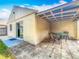 The covered patio offers an ideal outdoor dining space with neutral-toned pavers and table with chairs at 3120 Ginger Cir, Orlando, FL 32826