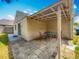 The covered patio offers an ideal outdoor dining space with neutral-toned pavers and table with chairs at 3120 Ginger Cir, Orlando, FL 32826