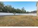 Large backyard features privacy fence and some trees at 3443 Berkshire Woods Ter, Deltona, FL 32725