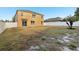 The backyard features a fence, a large grassy area, and the exterior of the home at 3443 Berkshire Woods Ter, Deltona, FL 32725