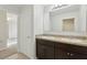 Modern bathroom featuring a double vanity with dark wood cabinets and a large mirror, exuding elegance at 3443 Berkshire Woods Ter, Deltona, FL 32725