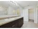 Bathroom with double sinks and dark cabinets with a walk-in shower nearby at 3443 Berkshire Woods Ter, Deltona, FL 32725