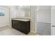 Bathroom featuring dual sinks, a large mirror, and access to the Primary bedroom at 3443 Berkshire Woods Ter, Deltona, FL 32725