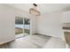 Bright dining area features luxury vinyl plank flooring, a sliding glass door, and stylish modern lighting at 3443 Berkshire Woods Ter, Deltona, FL 32725