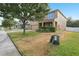 Inviting two-story home with well-maintained landscaping, front porch, neutral exterior paint, and lush shade tree at 3443 Berkshire Woods Ter, Deltona, FL 32725