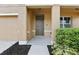Inviting front porch with a modern front door, manicured landscaping, and neutral exterior paint at 3443 Berkshire Woods Ter, Deltona, FL 32725