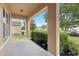 Covered front porch featuring concrete flooring, modern columns, and manicured landscaping at 3443 Berkshire Woods Ter, Deltona, FL 32725