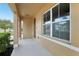 Covered front porch with modern design elements including concrete flooring and column supports at 3443 Berkshire Woods Ter, Deltona, FL 32725