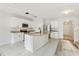 Bright kitchen features white cabinets, granite countertops, and a central island with a modern faucet at 3443 Berkshire Woods Ter, Deltona, FL 32725