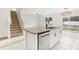 Bright kitchen featuring a granite island with sink, and a seamless transition into the living area with staircase at 3443 Berkshire Woods Ter, Deltona, FL 32725
