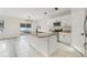 Bright kitchen features white cabinets, granite countertops, and a stylish island with a dark faucet at 3443 Berkshire Woods Ter, Deltona, FL 32725