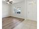 Cozy living room with hard flooring, a ceiling fan, and a large window at 3443 Berkshire Woods Ter, Deltona, FL 32725