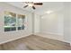 Bright living room featuring a ceiling fan, lots of windows, and new flooring at 3443 Berkshire Woods Ter, Deltona, FL 32725