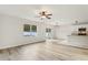 Bright living space featuring modern flooring, neutral walls, kitchen, and backyard access at 3443 Berkshire Woods Ter, Deltona, FL 32725