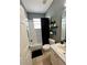 Clean bathroom with tile flooring, shower-tub combo with black curtain and stylish wall shelves at 3579 Maple Ridge Loop, Kissimmee, FL 34741
