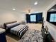 Large primary bedroom with neutral carpeting, a bed and large tv for relaxing at 3579 Maple Ridge Loop, Kissimmee, FL 34741