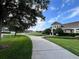 Charming clubhouse with well-manicured landscaping, sidewalks, and lush green lawns under a beautiful blue sky at 3579 Maple Ridge Loop, Kissimmee, FL 34741