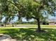 Scenic view of the community's common area with walking paths, lush greenery, and recreational space for outdoor activities at 3579 Maple Ridge Loop, Kissimmee, FL 34741