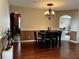 Dining room with hardwood floors, stylish chandelier, and a dark wood dining table set at 3579 Maple Ridge Loop, Kissimmee, FL 34741