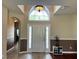 Spacious entryway featuring high ceilings, tiled floors, and a modern light fixture at 3579 Maple Ridge Loop, Kissimmee, FL 34741