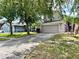 Charming two-story home with a well-maintained lawn, mature trees and a wide driveway at 3579 Maple Ridge Loop, Kissimmee, FL 34741