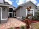 Charming front entrance with brick pathway and colorful landscaping at 3579 Maple Ridge Loop, Kissimmee, FL 34741