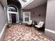 Inviting front porch with brick-paved area, seating, and decorative plants at 3579 Maple Ridge Loop, Kissimmee, FL 34741