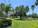 Beautiful front yard with mature trees, green grass, and manicured landscaping at 3579 Maple Ridge Loop, Kissimmee, FL 34741