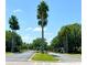A grand gated entrance to the community features palm trees, lush landscaping, and a secure entry for residents at 3579 Maple Ridge Loop, Kissimmee, FL 34741