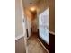 Hallway with tile floor, paneled walls, and a window allowing natural light to enter at 3579 Maple Ridge Loop, Kissimmee, FL 34741