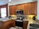 Well-appointed kitchen featuring stainless steel appliances, granite countertops, and stylish cabinetry at 3579 Maple Ridge Loop, Kissimmee, FL 34741