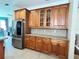 Spacious kitchen with granite countertops, stainless steel refrigerator, and plenty of storage at 3579 Maple Ridge Loop, Kissimmee, FL 34741