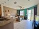 Bright living room and kitchen space with tile flooring and sliding glass doors to the patio at 3579 Maple Ridge Loop, Kissimmee, FL 34741