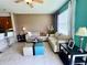 Comfortable living room featuring tile floors, neutral paint, and large window at 3579 Maple Ridge Loop, Kissimmee, FL 34741