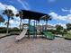 Vibrant playground with slides, climbing structures, and shade, perfect for Gathering fun and outdoor adventures at 3579 Maple Ridge Loop, Kissimmee, FL 34741