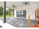 Back porch featuring ceiling fans, outdoor fireplace, and view of lake at 40 W Laurel St, Apopka, FL 32703