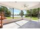 Covered back porch featuring tile floor, wood columns, and a gorgeous lake view at 40 W Laurel St, Apopka, FL 32703