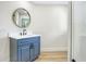 Stylish bathroom with a blue vanity, white countertop, round mirror and modern black faucet at 40 W Laurel St, Apopka, FL 32703