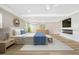 Main bedroom with light wood floors, fireplace, a modern ceiling fan, and an ensuite bathroom at 40 W Laurel St, Apopka, FL 32703