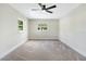 Bright bedroom with a modern ceiling fan and great natural light from large windows at 40 W Laurel St, Apopka, FL 32703