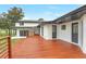 View of the home's deck featuring brown stained wood and access to multiple entrances at 40 W Laurel St, Apopka, FL 32703