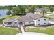 Stunning aerial view of a modern home with a well-manicured lawn, lake view, and a charming blue front door at 40 W Laurel St, Apopka, FL 32703