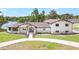 Stunning exterior view of the home with blue front door and well-maintained landscaping at 40 W Laurel St, Apopka, FL 32703