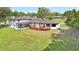 Expansive home with a well-maintained lawn and a deck perfect for outdoor entertaining at 40 W Laurel St, Apopka, FL 32703