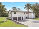 White two-story home featuring a large three-car garage and lush landscaping at 40 W Laurel St, Apopka, FL 32703